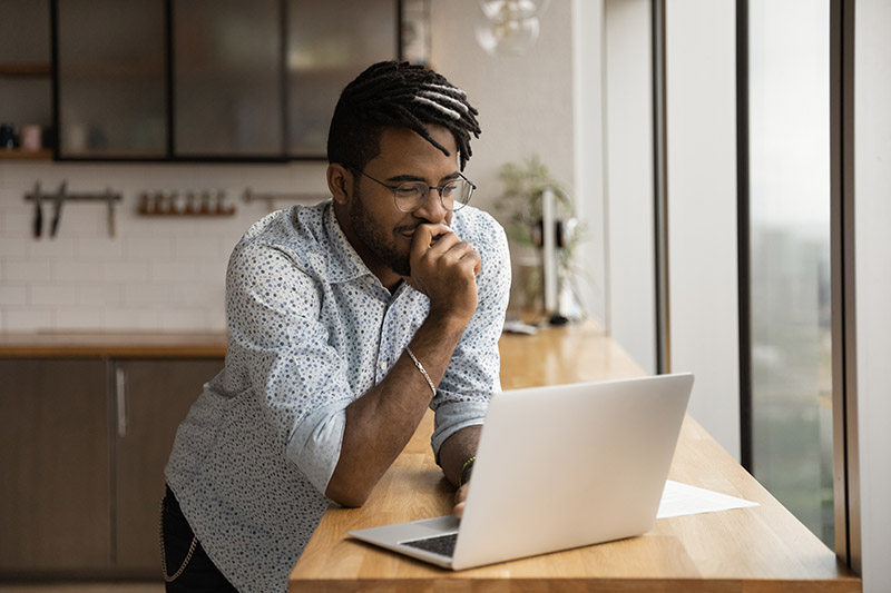 Man looking at computer thinking